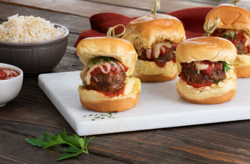 Three meatball sliders with marinara and cheese