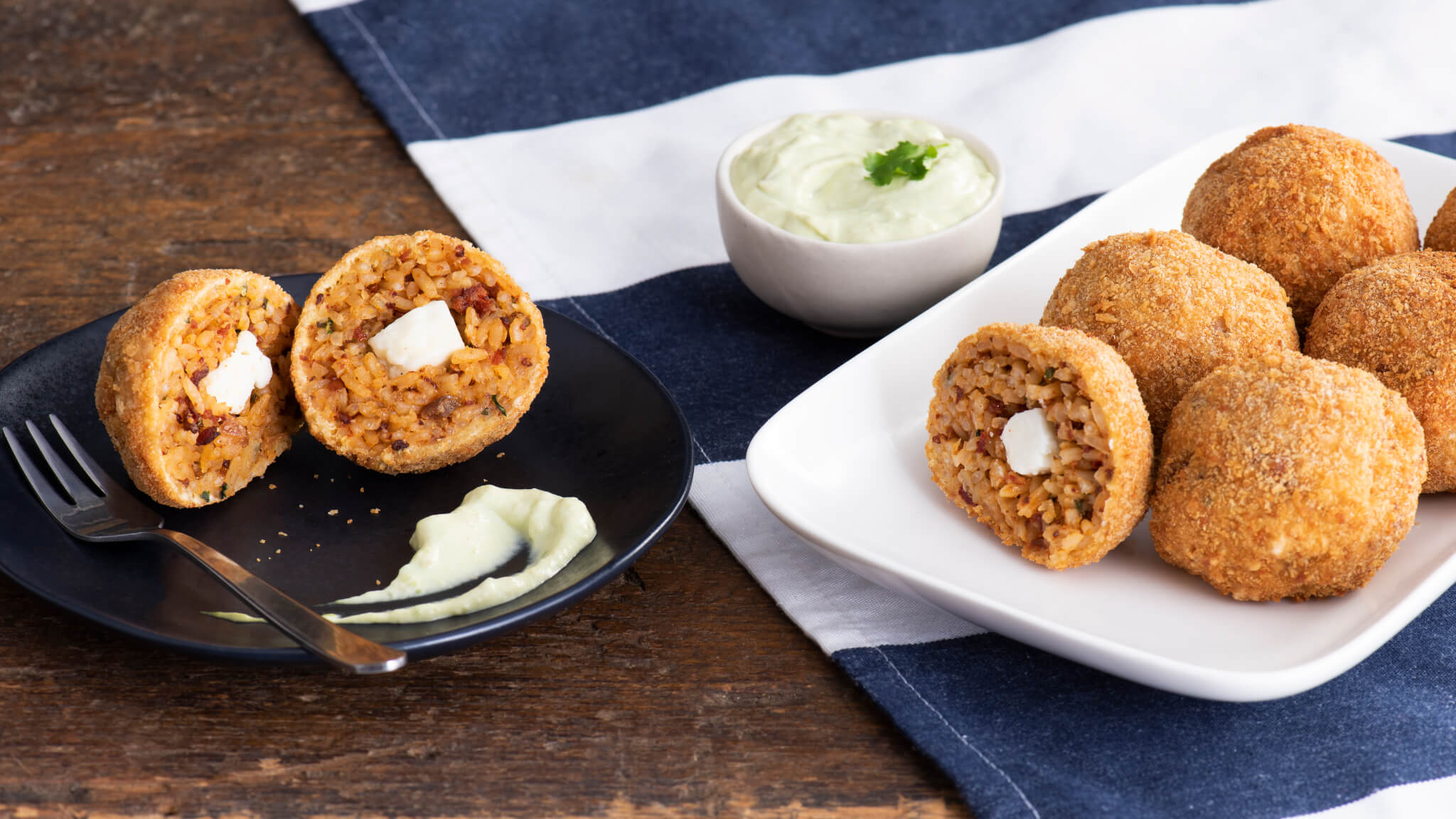 Fried rice croquettes filled with chorizo cream cheese with avocado cream