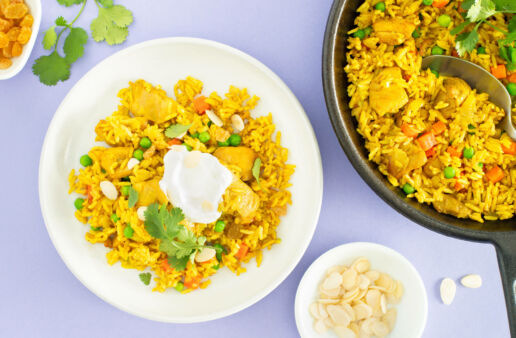 Chicken biryani rice bowl with chopped cilantro and greek yogurt