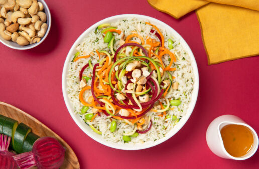 Salad rice bowl with spiralized vegetables and cashews