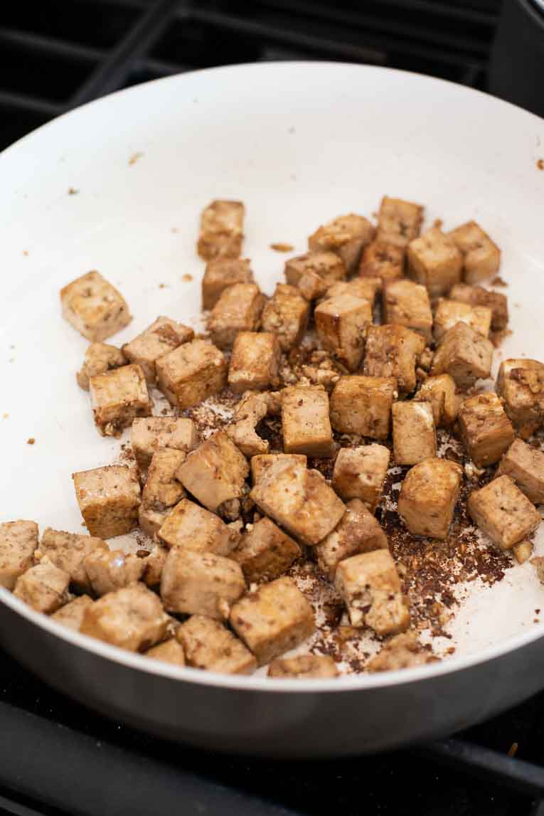 cooking tofu in the pan with sesame oil