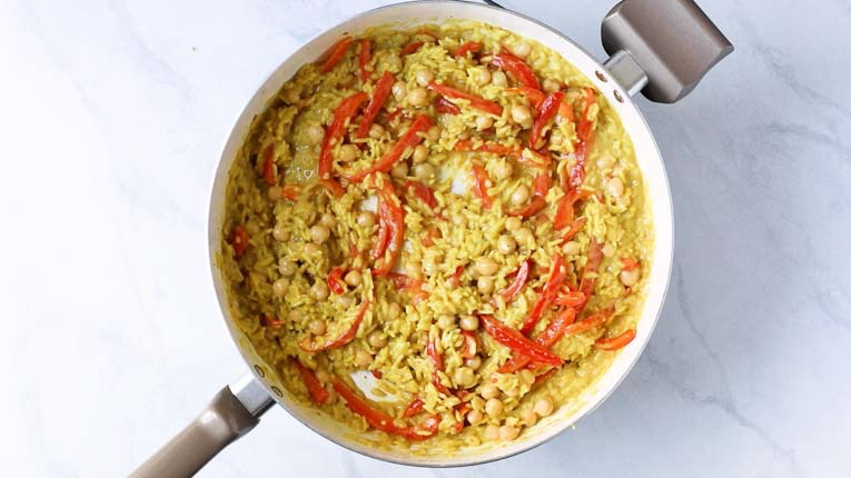 Red peppers with curry rice in a pan
