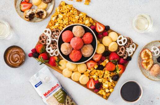 colorful-dessert-board-with-sweet-arancini-fresh-fruit-caramel-pop-corn-and-pretzels